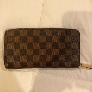 Louis Vuitton damier ebene zippy wallet 
Basically new
